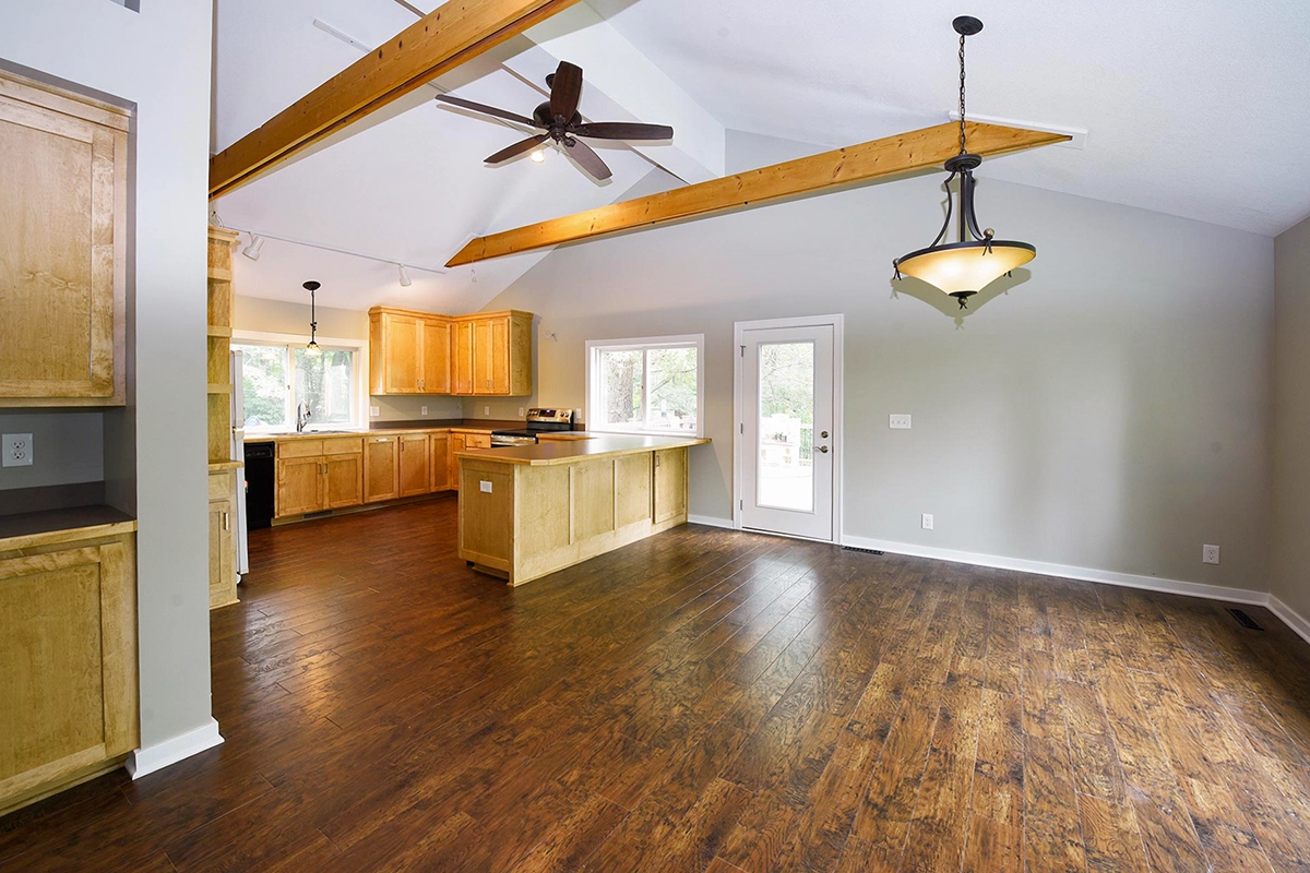 Completed open-concept home renovation in Ham Lake MN with exposed beams and LVP flooring